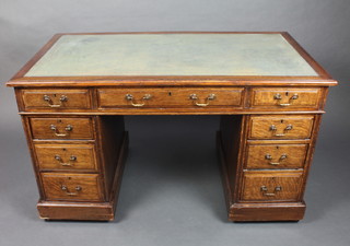 A Victorian oak pedestal desk with inset green leather writing surface with 1 long and 8 short drawers 29"h x 48"w x 26"d