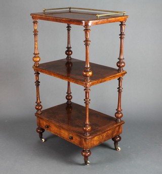 A Victorian inlaid figured walnut 3 tier what not with brass gallery fitted a drawer raised on turned supports with ceramic castors 41"h x 24"w x 15"d