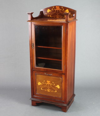 An Edwardian Art Nouveau inlaid mahogany music cabinet, the raised back with 3/4 gallery inlaid flowers above a cupboard fitted adjustable shelves enclosed by glazed panelled doors, the base fitted a fall front raised on bracket feet 48"h x 19"w x 14"d