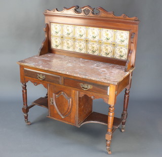 An Edwardian walnut wash stand with raised tiled splash back and pink veined marble top, the base fitted 2 long drawers above a cupboard flanked by a recess raised on turned supports 50"h x 42"w x 20"d  