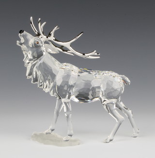 A Swarovski figure of standing stag No 291431/760800004, designed by Adie Stocker, 5"h contained in a fitted box