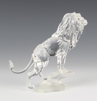 A Swarovski figure of a Lion on a rock, No 269377/7610000004, designed by Martin Zendron, 5"h contained in a fitted box