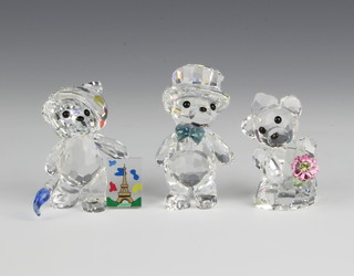 A pair of Swarovski figures "Kris Bear, You and I Bride and Groom" No 84936/940000063 by Heinz Tabbershon, 1 1/4"h together with "Kris Bear International" No 883412/9400000190, designed by Heinz Tabbershon, 1 1/2"h, both contained in a fitted box