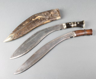 A Kukri with 12 1/2" blade, buffalo horn grip and silver mounts together with one other with 13 1/2" blade and wooden grip