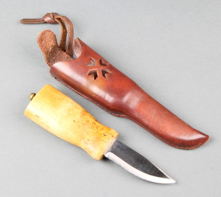 A Norwegian skinning knife, the 6 1/4" steel blade marked Helle, with curley birch grip complete with leather scabbard
