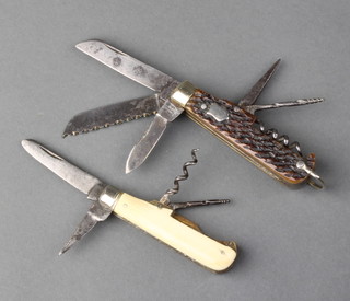 An early 20th century multi blade knife, stamped Sheffield, England with 2 blades, saw, corkscrew, gimlet, leather punch, the jigged handle with white metal bolster together with a 19th Century knife stamped Mappin & Webb, Sheffield with 2 blades, corkscrew and gimlet with ivory handle