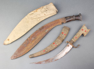A Kukri with 14" blade, carved hardwood grip and contained in a webbing scabbard together with an Eastern curved dagger with 9" blade contained in a wooden scabbard