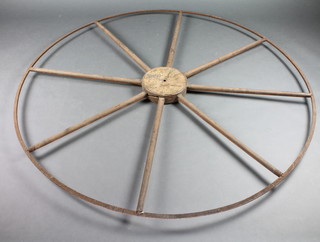An elm and iron seven spoked wheel 64"d possibly part of a way wiser
