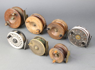 A brass centre pin fishing reel 3", a wooden and brass star back fishing reel 4 1/2", 3 wooden centre pin fishing reels and 2 other centre pin fishing reels