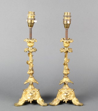 A pair of 19th Century gilt ormolu candlesticks raised on triform bases converted for use as table lamps 14"h