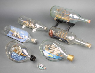 A model ship in a bottle 'Endeavour' in a Haig whiskey bottle and one other, a miniature ship in a bottle together with 4 others