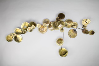Sasa, a polished brass wall sculpture "Lily Pads" 64"h x 32"w signed