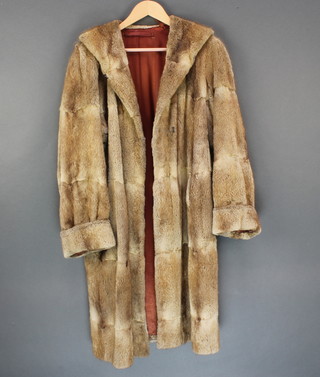 A lady's full length light fur coat 