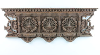 A Nepalese, labelled the Everest Wood Carving Institute,  a rectangular pierced hardwood plaque decorated three peacocks 10" x 24"