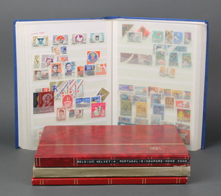 A stock book of various mint and used Soviet Russian stamps 1960-1976, an album of various mint and used world stamps inc Portugal, Singapore and Hong Kong, an album of various Liberian mint and used stamps and a stock book of various Malaysian used stamps