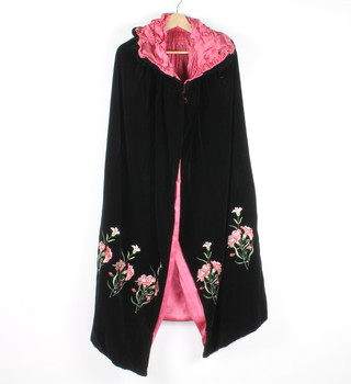 A Victorian black velvet evening cape with pink lining, embroidered flowers