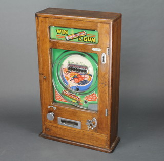 A Rowntree's wall mounted fruit gum dispensing pinball machine contained in an oak case 32"h x 19"w x 7"d. The machine is fully functional and comes with keys and 4 old pennies ( alas no Fruit Gums )
