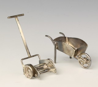 A miniature silver model of a wheel barrow London 1996 78mm and a do. lawn mower 1997 90mm 56 grams 