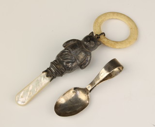 A Victorian repousse silver rattle in the form of a cat with mother of pearl teether, Chester 1884 together with a silver spoon