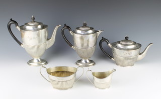 A Victorian silver 5 piece tea and coffee set comprising tea pot, coffee pot, hot water pot, sugar bowl and milk jug, the demi-fluted decoration with ebony mounts, Sheffield 1893.Maker Mappin & Webb, Gross 67oz