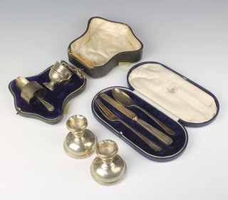 An Art Deco silver 3 piece Christening set, a ditto cased set and a set of dwarf candlesticks