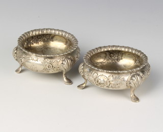 A pair of Victorian repousse silver table salts on pad feet, Sheffield 1883, 118 grams 