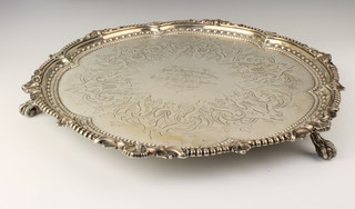A Victorian silver salver with scroll and beaded rim with chased inscription on claw and ball feet, Sheffield 1885. Maker Martin Hall & Co, 1740g