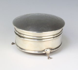 A circular silver trinket box chased with ribbons and swags on pad feet, Birmingham 1919, 4 1/2"