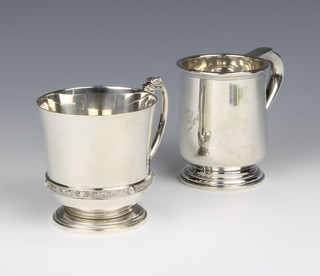 An Arts and Crafts style silver mug with serpent handle, Birmingham 1936, Adie Bros, A Georgian style mug with rubbed marks, 252 grams