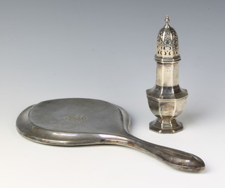 A silver octagonal shaker, Birmingham 1915, 88 grams and an Edwardian silver backed dressing table mirror, Birmingham 1910