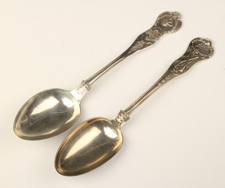 A Victorian silver presentation spoon, London 1862, decorated with firearms, another Birmingham 1910, 170 grams
