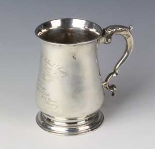 A George III mug with fancy S scroll handle and presentation inscription dated 1878, London 1767, maker William Turton, 5" h 384 grams
