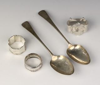 A George III silver table spoon, London 1803, one other and 3 napkin rings, 180 grams