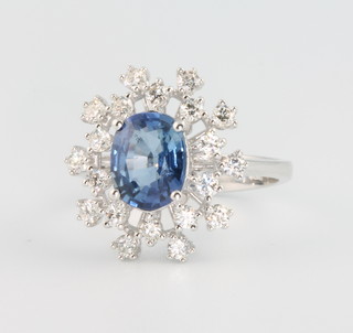 An 18ct white gold oval sapphire and diamond cluster ring, the centre stone approx 2.13ct surrounded by 20 brilliant cut diamonds approx 0.6ct, size M
