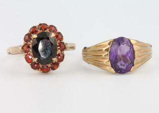 A 9ct yellow gold amethyst set ring size N 1/2 and a do. garnet set cluster ring size M