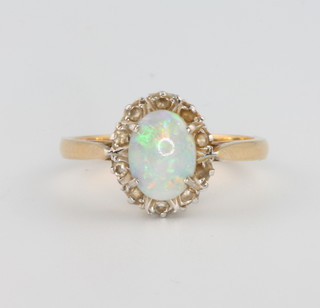 An 18ct yellow gold opal and diamond cluster ring, size M