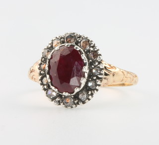 A yellow gold ruby and diamond cluster ring, size O 1/2