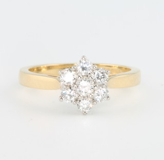 An 18ct yellow gold seven stone diamond daisy ring, size K