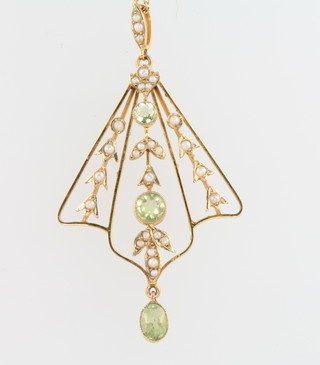 An Edwardian 9ct yellow gold peridot and seed pearl open brooch on a ditto chain