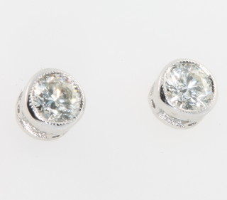 A pair of 18ct white gold single stone diamond earstuds, approx 0.04ct
