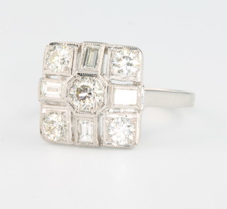 An 18ct white gold Art Deco style diamond ring comprising brilliant and baguette cut stones, approx 1.25ct, size M