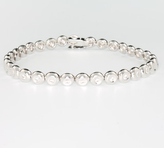 An 18ct white gold 32 brilliant cut diamond bracelet in a rub over setting,  approx 1.0ct, 188mm 