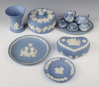 A Wedgwood blue Jasperware cylindrical jar and cover 2", a ditto waisted vase 4"h, the base impressed 60, a heart shaped trinket box 2"h, a miniature tea service comprising oval tray, teapot, cream jug, sugar bowl and coffee pot, an ashtray and a Royal Wedding plate