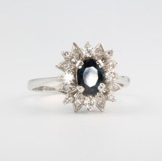 An 18ct white gold sapphire and diamond cluster ring size P