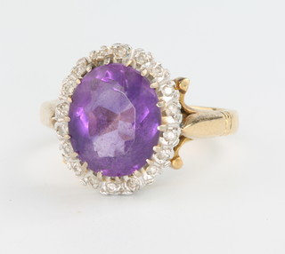 An 18ct yellow gold amethyst and diamond cluster ring size N