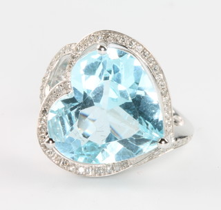 A 14ct white gold heart shaped blue topaz and diamond ring the centre topaz 9.8ct size M1/2