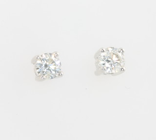A pair of white gold diamond stud earrings, 0.6ct
