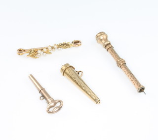 A yellow gold bar brooch, a propelling pencil, a watch key and a case