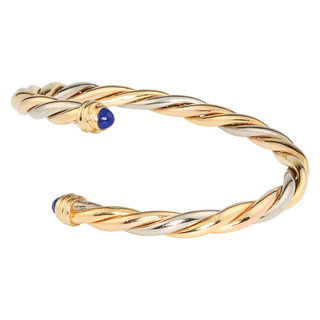 Cartier, an 18ct two colour rope twist bangle with cabochon sapphire terminals, dated 1990, No 928545