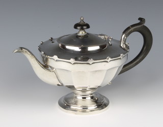 A silver teapot with ebony mounts, Birmingham 1923, 406 grams gross